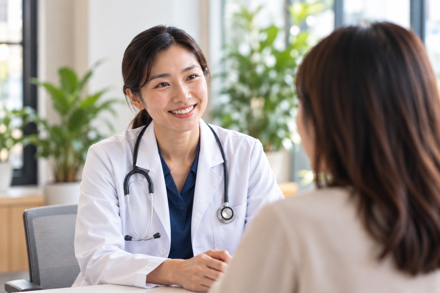 A doctor listening to a patient in a bright consultation room